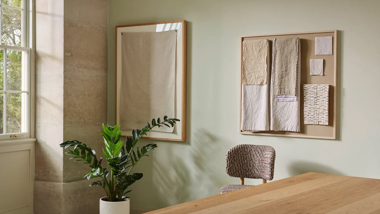 Sunlit craft studio corner with pinboard, plant and small framed textile